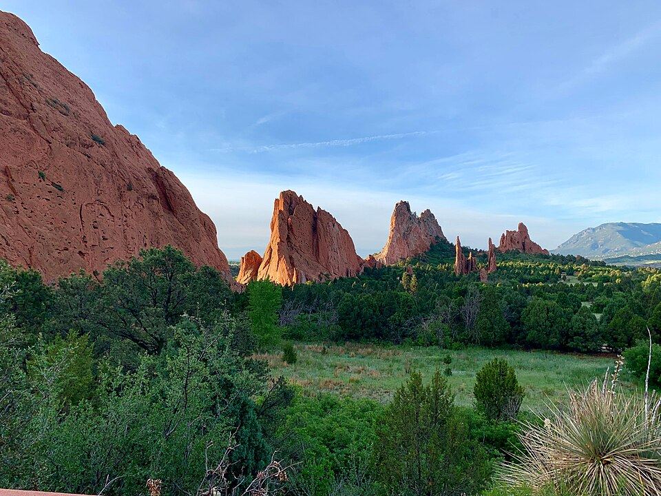 Towering red sandstone formations at Garden of the Gods with Pikes Peak in background