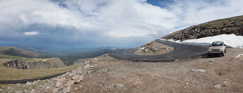 Winding mountain road with dramatic alpine views