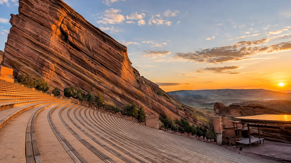 the sandstone monoliths and seating rows of Red Rocks Amphitheatre at golden hour