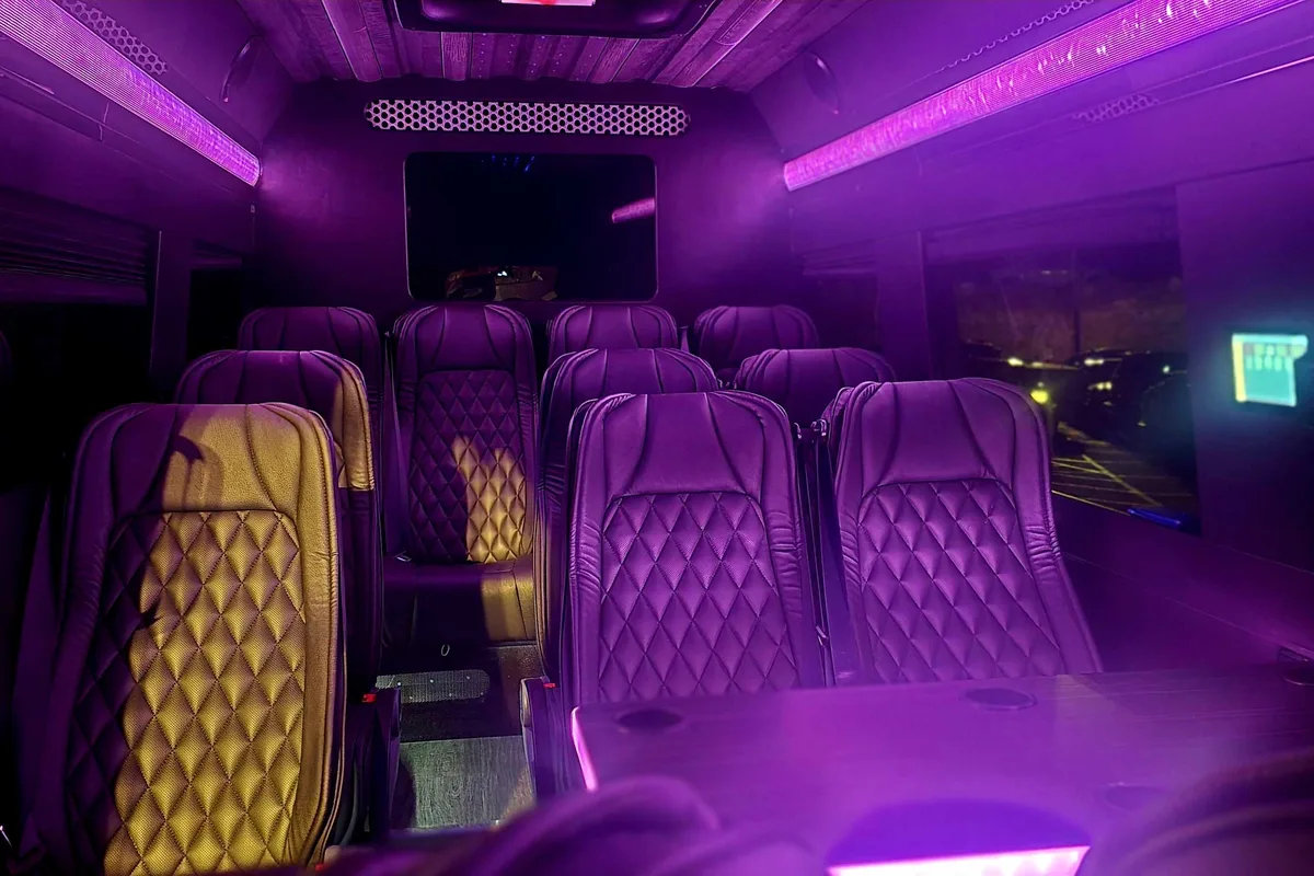 Executive Van interior — ambient purple lighting with diamond-stitched seats