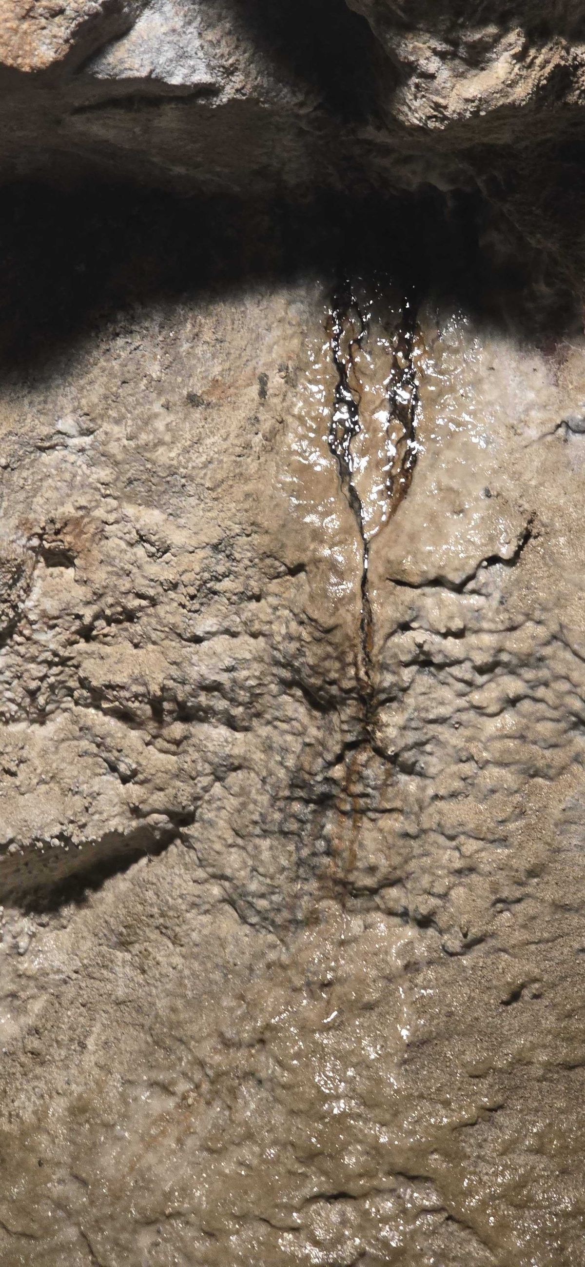 Dragon's blood — dark silver oxide seepage trickling down the rock wall inside the Lebanon Mine