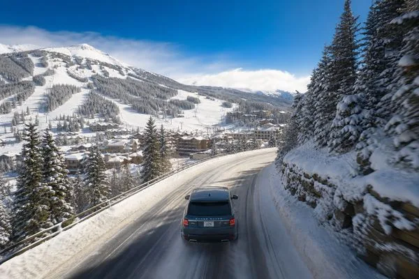 Luxury SUV on snowy Colorado mountain road