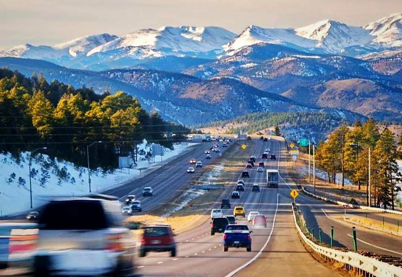 Interstate 70 heading west from Denver toward the snow-capped Front Range