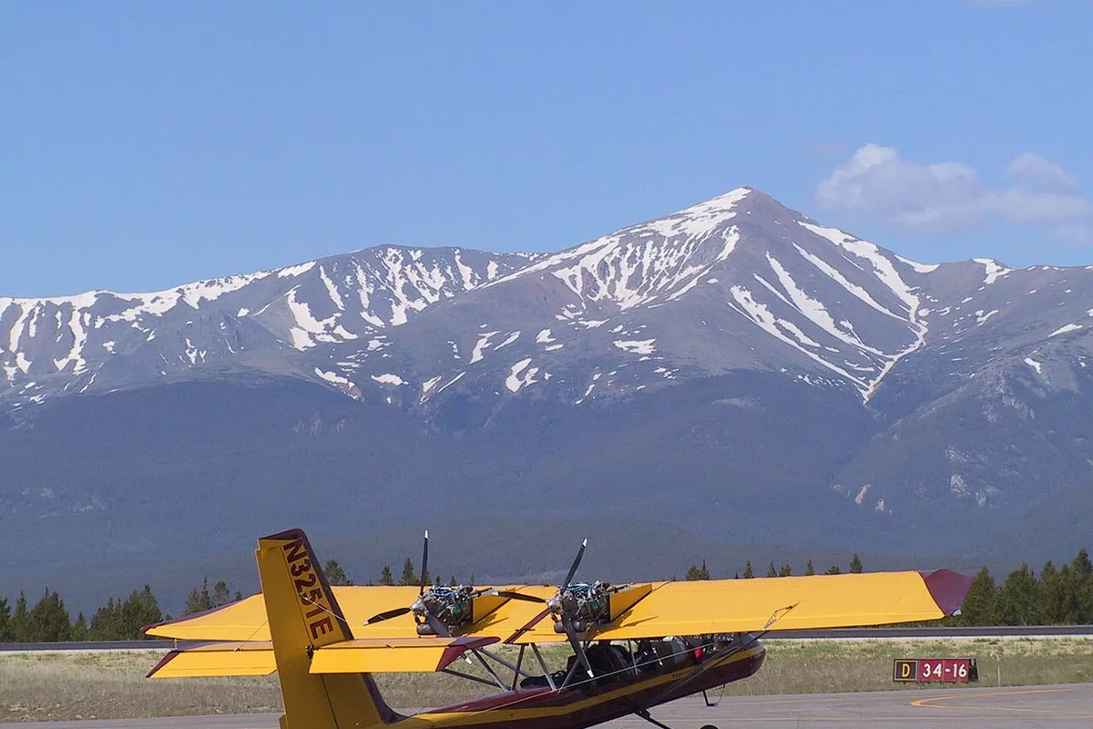 A light aircraft on the ramp at Lake County Airport in Leadville, Colorado, with Mount Massive behind it