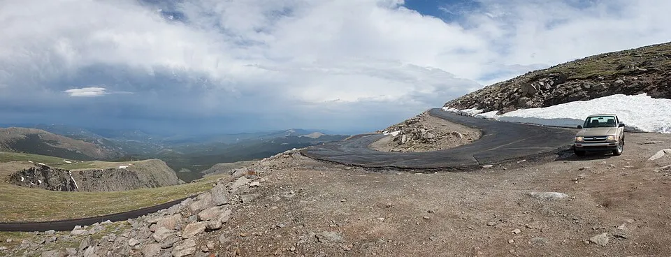 Winding mountain road with dramatic alpine views