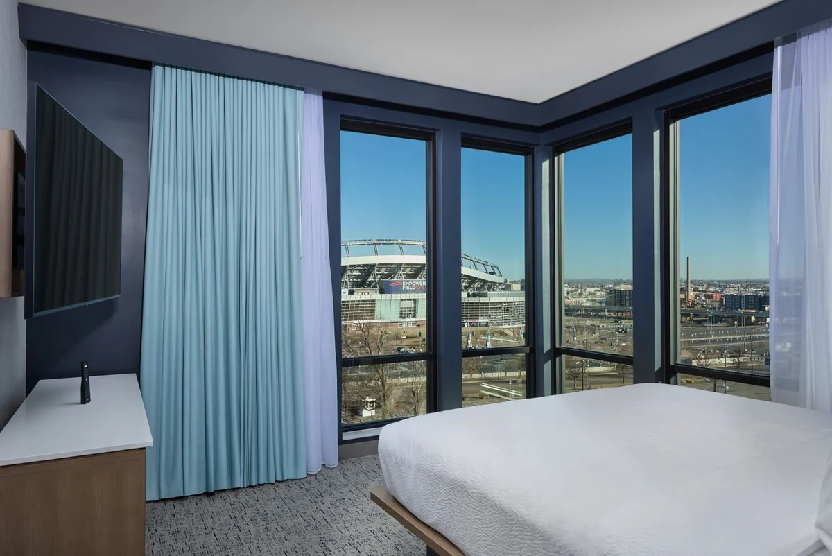 Guest room with corner windows overlooking Empower Field at Mile High