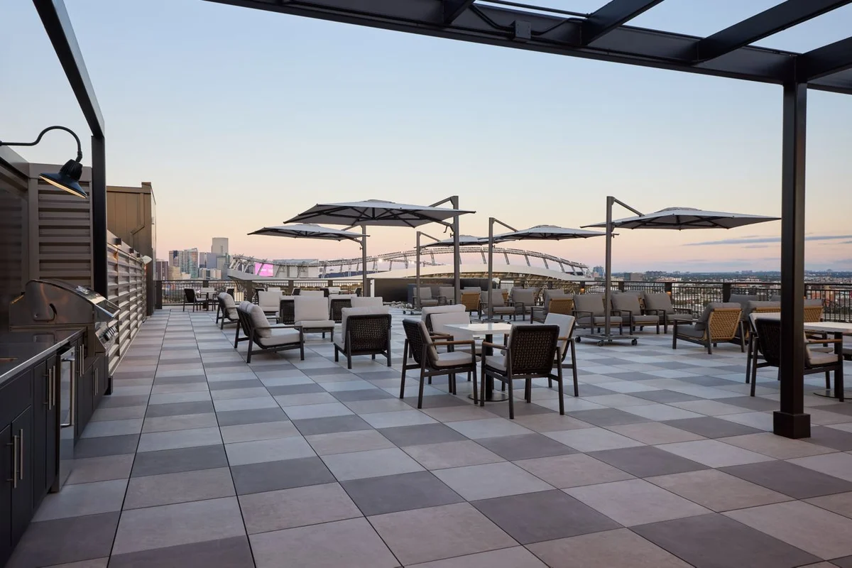 Rooftop terrace at Courtyard by Marriott Denver Downtown West at sunset overlooking Empower Field