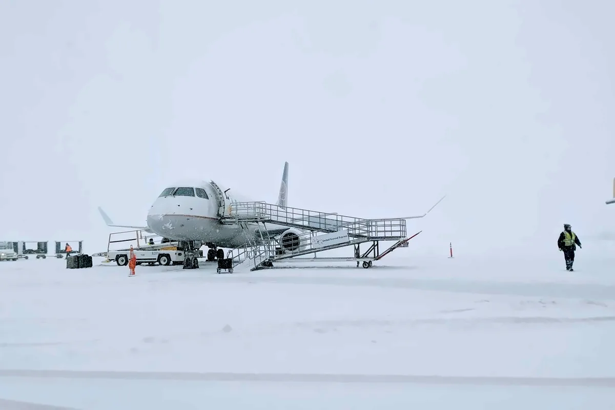 United Express regional jet at the airstairs during heavy snowfall at Yampa Valley Regional Airport in Hayden