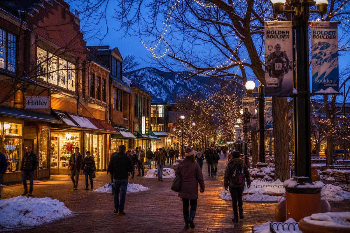 Winter evening on Pearl Street in Boulder with snow and lights