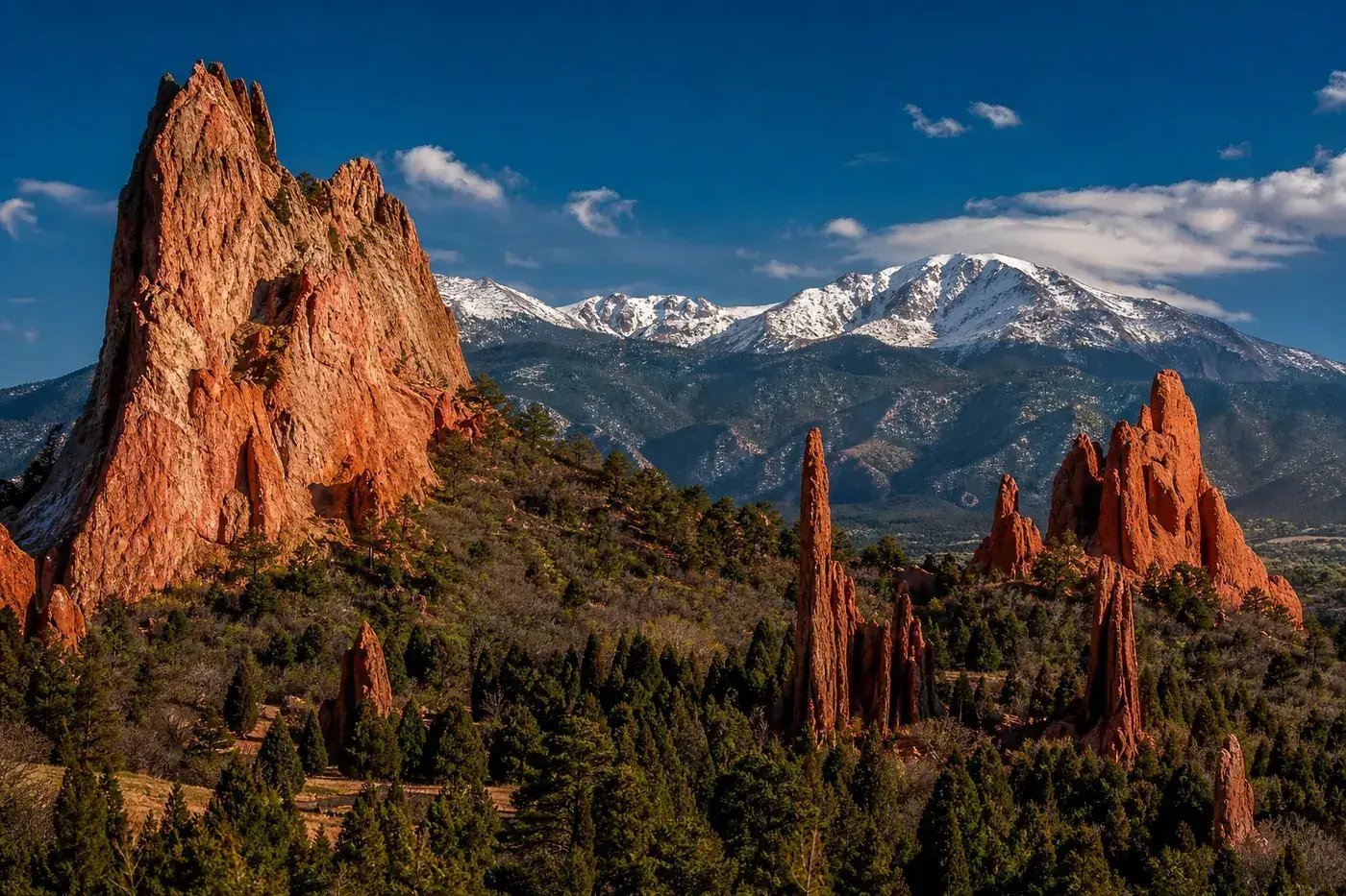 Garden of the Gods red sandstone formations with snow-capped Pikes Peak behind